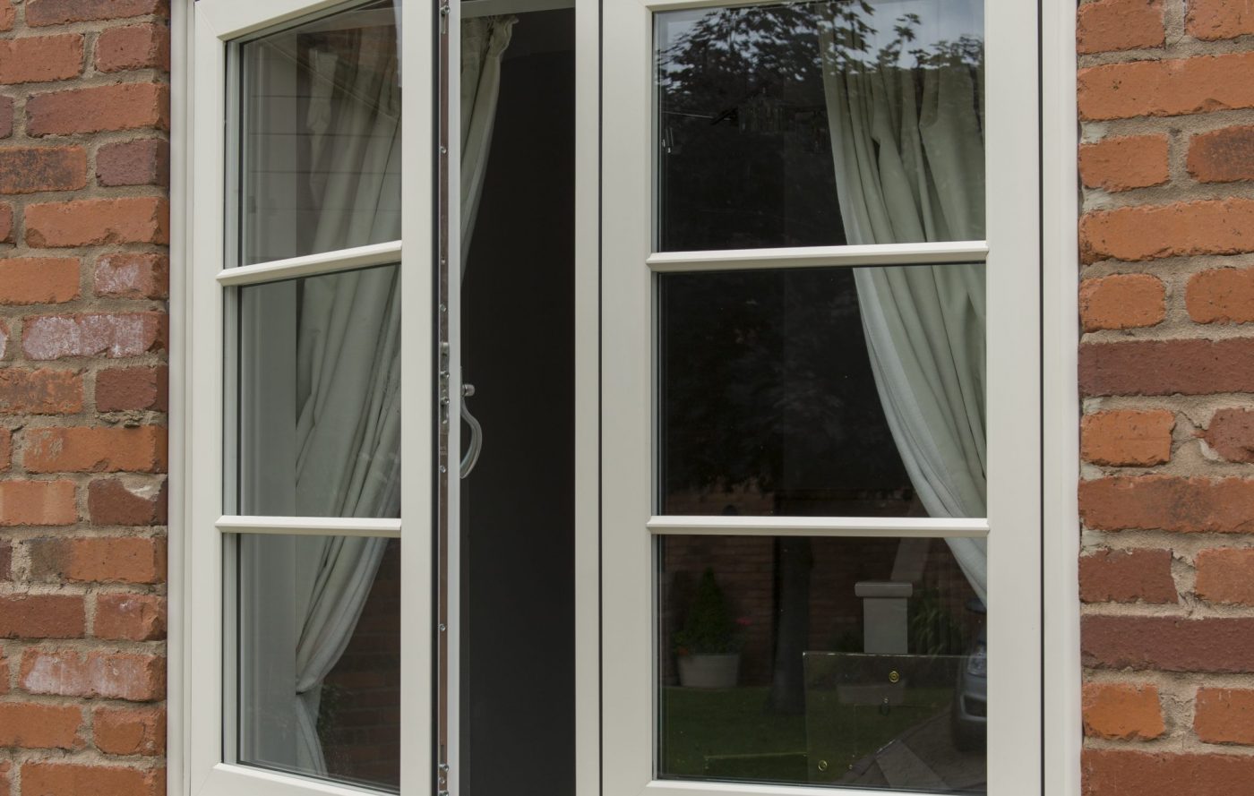 White uPVC window on a brick wall with one window open.