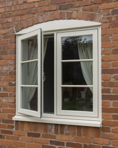 White uPVC window on a brick wall with one window open.