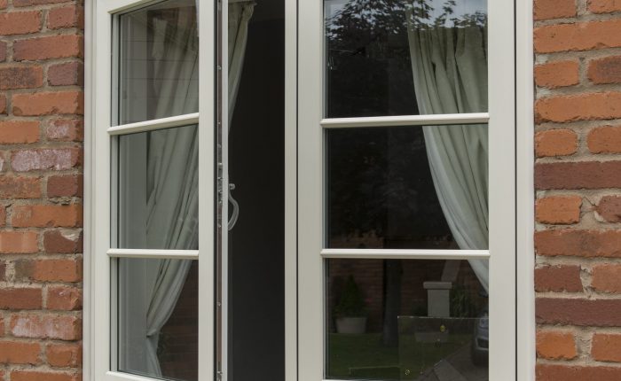 White uPVC window on a brick wall with one window open.